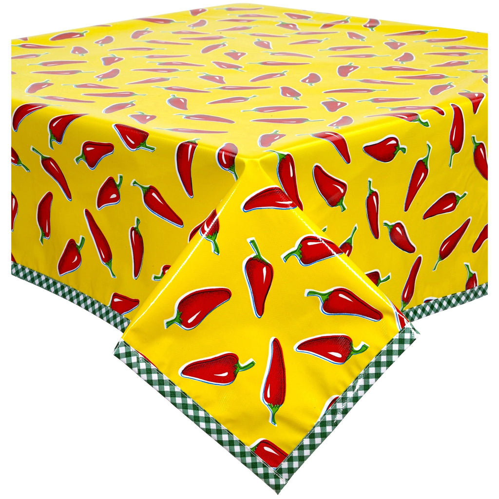 chili peppers on yellow oilcloth tablecloth with dark green gingham trim