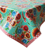 Freckled sage oilcloth tablecloth flower blooms on aqua with red gingham trim