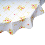 round bows and bouquet gold on white oilcloth tablecloth closeup