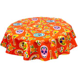 freckled sage round skulls on orange oilcloth tablecloth