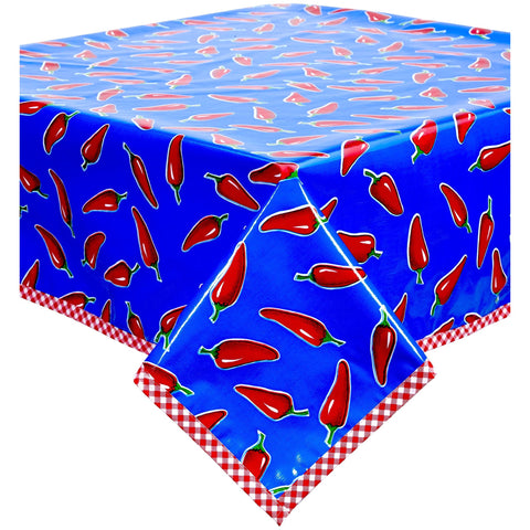 chili peppers on blue oilcloth tablecloth with red gingham trim