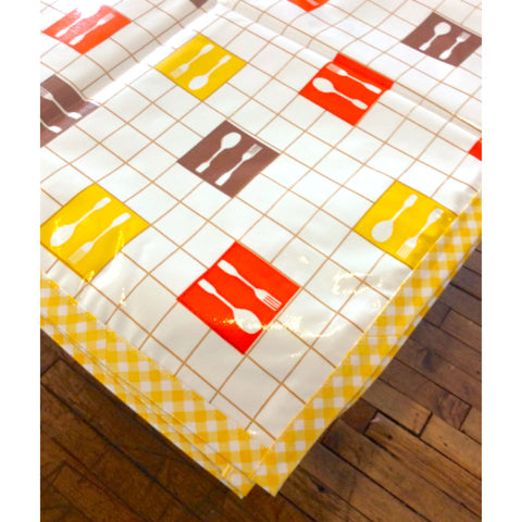 forks and spoons brown tablecloth with yellow gingham trim 