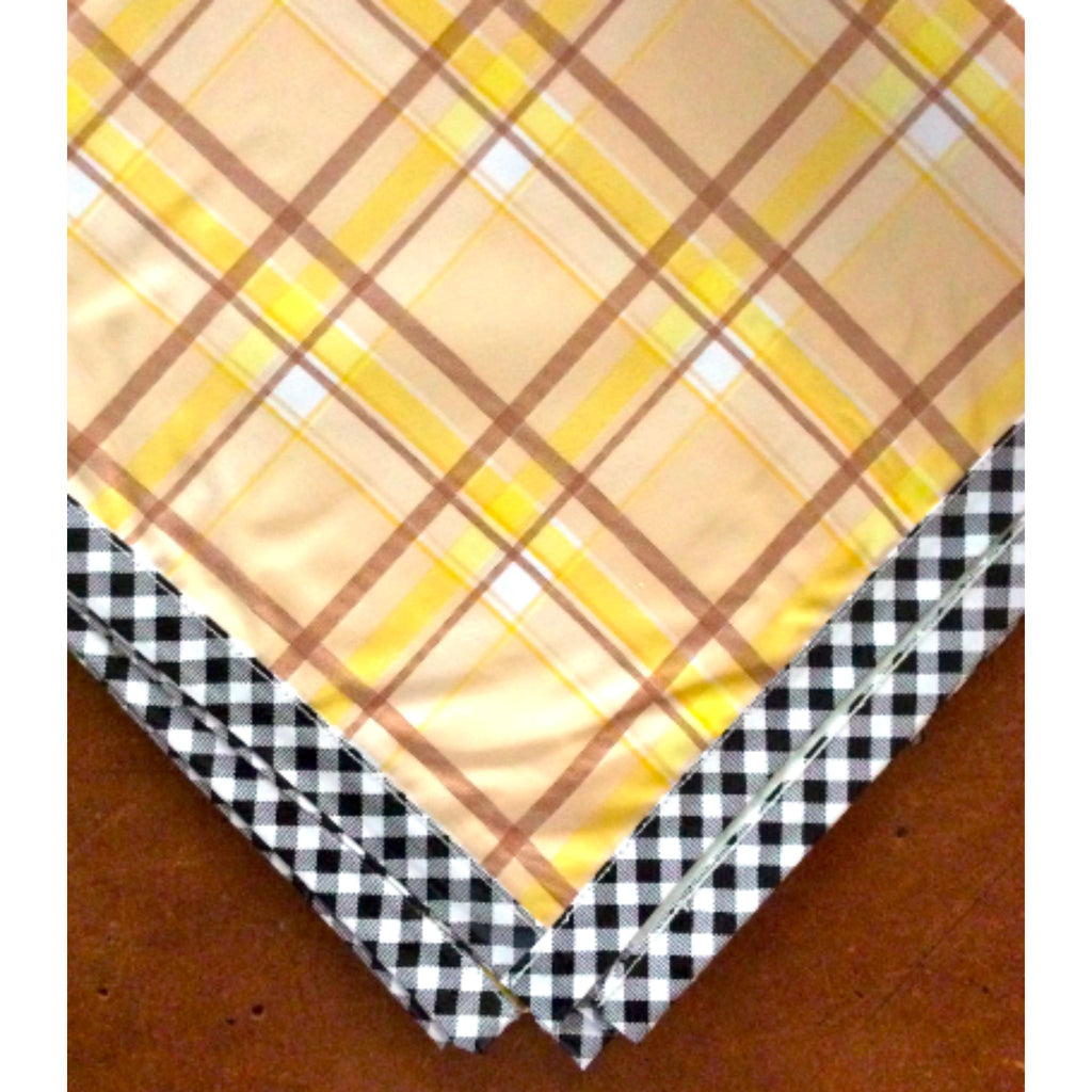 plaid tan and yellow oilcloth tablecloth with black gingham trim