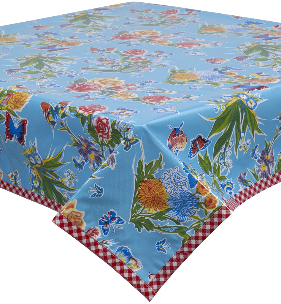 Freckled Sage Oilcloth Tablecloth  Butterfly and flowers on solid Light Blue with red gingham trim